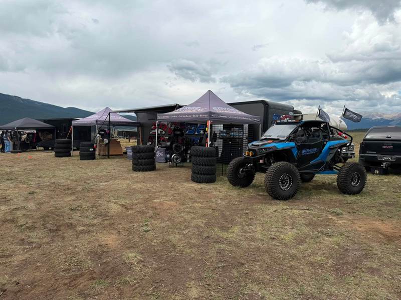 The Savage setup at Taylor Park: tents, stacked tires and the blue RZR