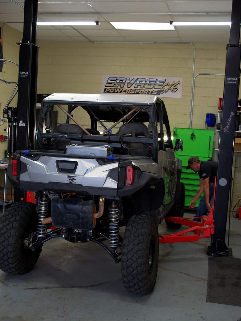 Polaris General on the lift in the Savage Powersports service bay