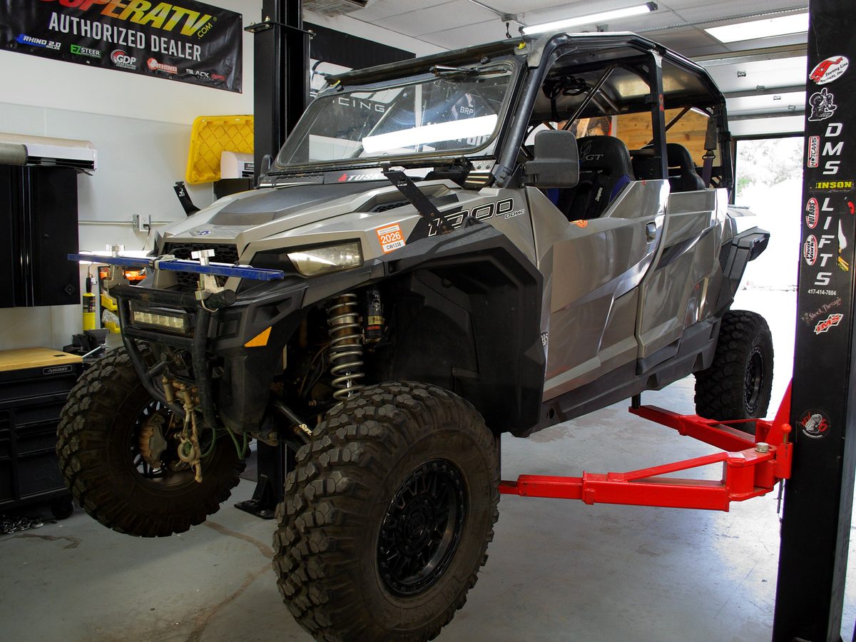 Polaris General on the lift in a Savage Powersports bay