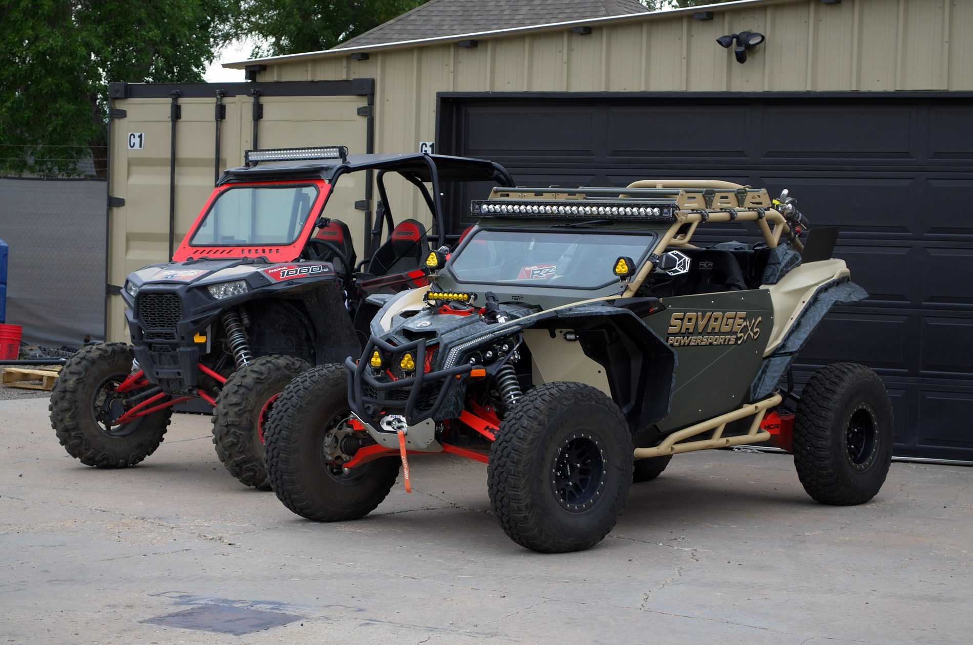 A Savage Powersports Can-Am Maverick X3 and a Polaris RZR outside the shop in Pueblo